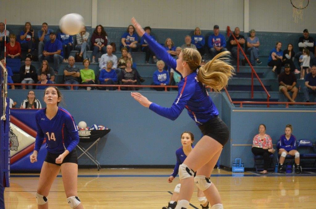 Jentri Jackson (2) slams one for a score as Ava Burroughs (14) looks on against Rains in Quitman’s win last week.
